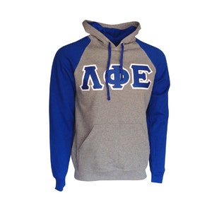 May include: A gray and royal blue hooded sweatshirt with the Greek letters "ΛΦΕ" in blue on the front.