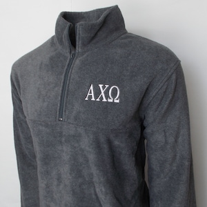 May include: A gray fleece pullover with a white embroidered "AXO" logo.