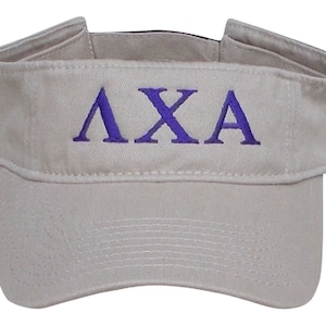 May include: A khaki visor with a purple embroidered "AXA" logo.
