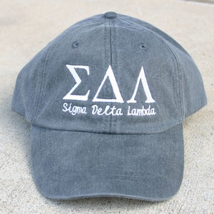 May include: A dark gray baseball cap with white embroidered letters that read "&Sigma;&Delta;&Lambda; Sigma Delta Lambda".