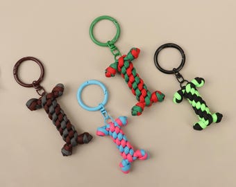Creative Bone-Shaped Paracord Keychain - Two-Tone Backpack Pendant, Multifunctional Everyday Accessory & Practical Zipper Decoration