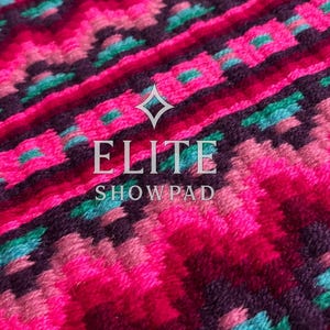 May include: Close-up of a vibrant, patterned textile. The design features a repeating geometric pattern in shades of pink, teal, and purple. The text "ELITE SHOW PAD" is centered on the image. The textile appears to be a show pad.