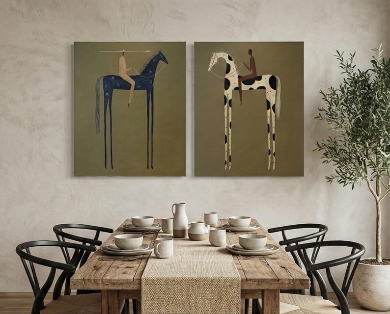 May include: Two framed art prints depicting stylized horses with riders. One horse is dark blue with white star-like patterns, the other is white with black spots. Both have long, thin legs and are set against a muted green background.