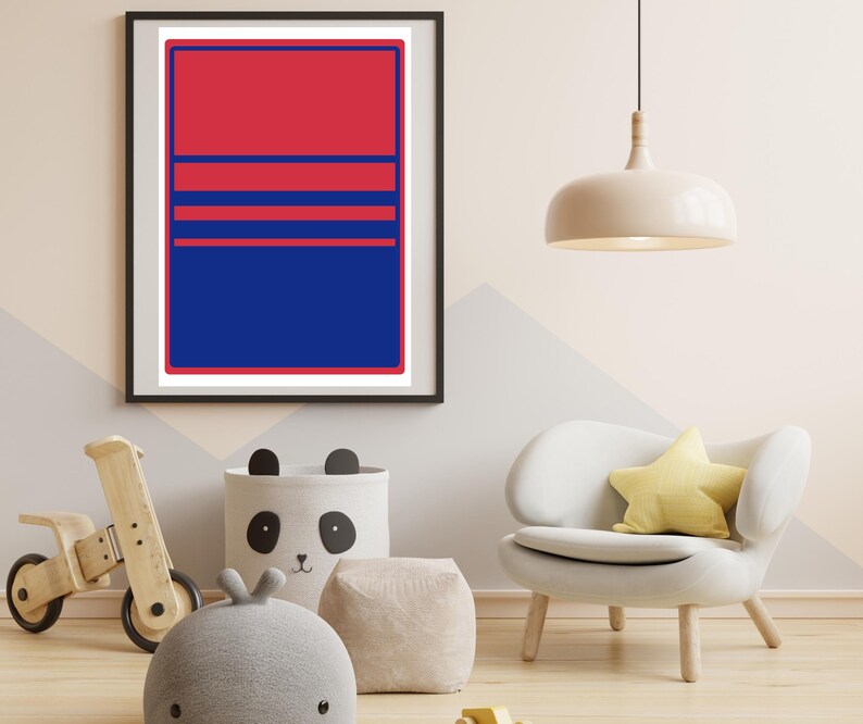 May include: A framed art print with a striking red and blue geometric design. The artwork features a rectangular shape divided into sections with horizontal lines. The print is displayed in a room with children's decor, including a wooden toy and a panda-themed storage bin.
