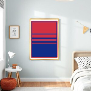 May include: A framed abstract art print with a red and blue colour block design. The artwork features a gold frame and is displayed on a light blue wall. The print has horizontal stripes.