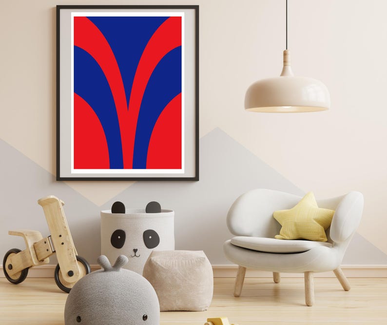 May include: A framed abstract art print with a bold design in red and blue. The artwork features a symmetrical pattern of curved shapes. The print is displayed in a modern interior setting with a white chair and a panda-themed storage bin.