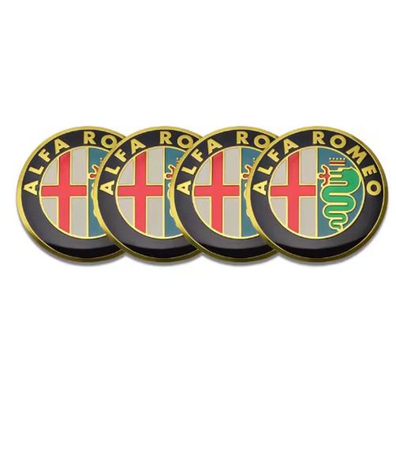 May include: Four circular Alfa Romeo emblems. Each emblem features a red cross on a white background, a green and blue background, and a gold border. One emblem has a green serpent.
