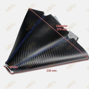 May include: Black carbon fibre gear shift boot with blue stitching. The boot measures 23 cm long, 3 cm wide, and has a diameter of 27 cm. The product is designed for automotive use.