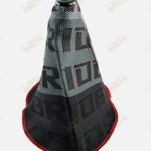 May include: A black and gray shift boot with the word "RIDE" printed on it. The boot has a red trim around the bottom and a black top.