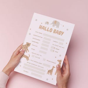 May include: A light pink baby stats sheet with the words "HALLO BABY" at the top. The sheet has fill-in-the-blank sections for baby's name, birthdate, eye color, hair color, weight, height, and more. There are animal illustrations.