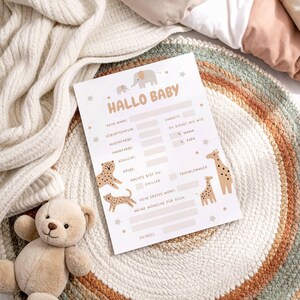 May include: A baby announcement card with the words "HALLO BABY" in a playful font. The card features illustrations of animals, including elephants, giraffes, and leopards. It has spaces to fill in baby's details.