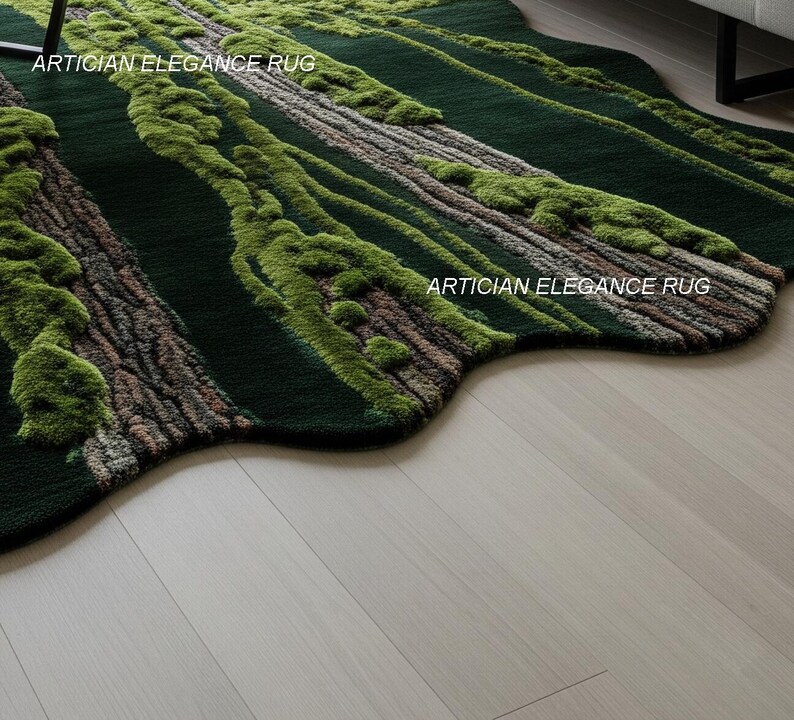 May include: A dark green rug with a forest-like design. The rug features textured areas resembling tree trunks and moss, with the text "ARTICIAN ELEGANCE RUG" visible. The rug has an irregular, organic shape and is placed on a light wood floor.