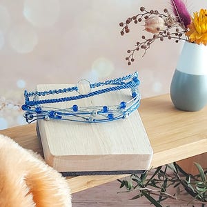 Peut inclure: Une tasse en céramique blanche avec une anse noire et le texte "But first, coffee" dans un style manuscrit. La tasse est posée sur une surface blanche. La tasse mesure 10 cm de haut.