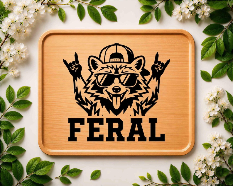 May include: A wooden tray with a black graphic of a raccoon wearing sunglasses and a backwards baseball cap, giving a rock and roll hand gesture. The word "FERAL" is printed in bold, black letters below the raccoon.