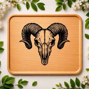 May include: A detailed black and white illustration of a ram skull with large, curved horns. The skull is centered on a light brown wooden tray, surrounded by white flowers and green leaves, creating a natural, decorative theme.