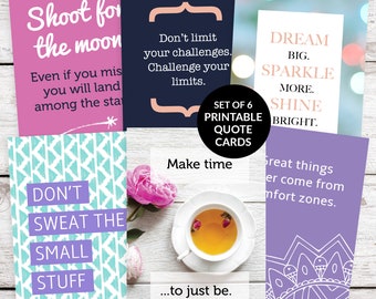 May include: Set of six printable quote cards with inspirational messages. The cards feature a variety of colors and patterns, including pink, blue, purple, and white. The text on the cards includes quotes such as "Shoot for the moon", "Don't limit your challenges", "Dream big, sparkle more, shine bright", and "Don't sweat the small stuff".