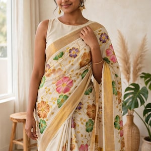 May include: An off-white saree featuring a repeating floral pattern in shades of pink, purple, orange, and green. The garment includes a wide gold border along the edges and a sleeveless blouse in a matching off-white tone, creating a cohesive look.