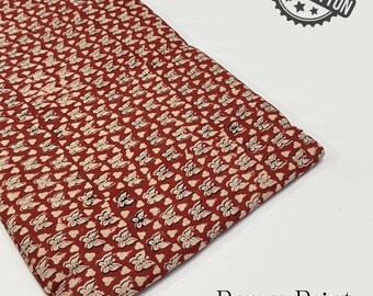 May include: Folded red fabric with a repeating white butterfly pattern. The fabric is labeled "100% Cotton" and "Bagru Print, Pure Cotton Fabric."