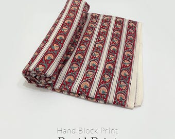 May include: Rolled and unfolded pure cotton fabric with a hand block print. The fabric features vertical stripes in red, white, and green, with a floral pattern. The text on the image reads "Hand Block Print", "Rapid Print", and "Pure Cotton Fabric".