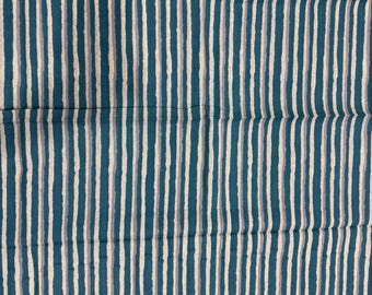 May include: A fabric with a repeating vertical stripe pattern. The stripes alternate between teal, off-white, and a muted gray. The fabric has a slightly wrinkled texture, suggesting it may be linen or a similar material.
