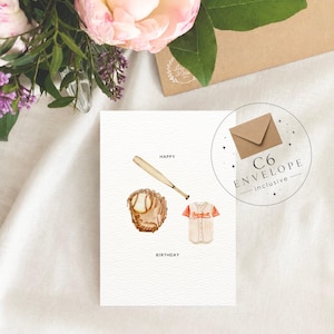 May include: A white greeting card featuring a watercolor illustration of a tan baseball bat, a brown leather baseball glove with a ball, and a white and orange baseball jersey. The text reads HAPPY BIRTHDAY. A circular graphic indicates a C6 envelope is included.