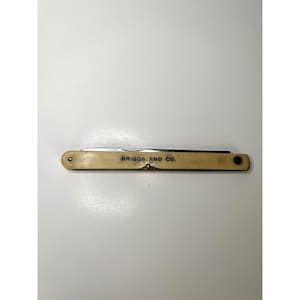 May include: A vintage pocket knife with a cream-colored handle and the text "BRIGGS AND CO." printed on the handle. The knife is closed, with a visible blade edge. The knife is a classic tool.