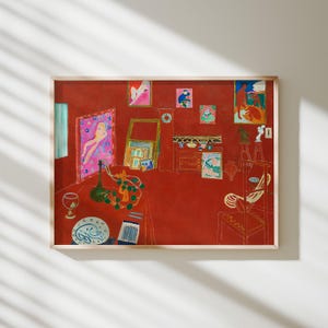 May include: A framed art print featuring a red-toned interior scene with various paintings on the walls, a table in the foreground holding a green bottle, a patterned plate, and a box of pencils, all rendered in a flat, expressive painterly style.