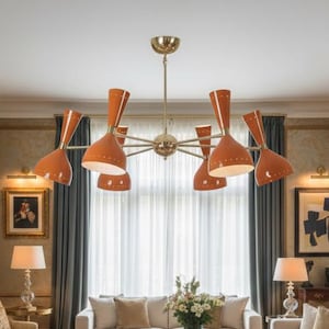 May include: An elegant living room featuring cream sofas, a patterned rug, and a fireplace. The room is lit by a brass chandelier with orange shades. Artwork and decorative items enhance the sophisticated atmosphere.