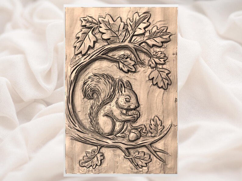 May include: A detailed wood carving of a squirrel sitting on a branch, holding a nut. The squirrel is surrounded by oak leaves and branches, all carved in a natural wood tone. The artwork is rectangular and mounted on a light-colored background.