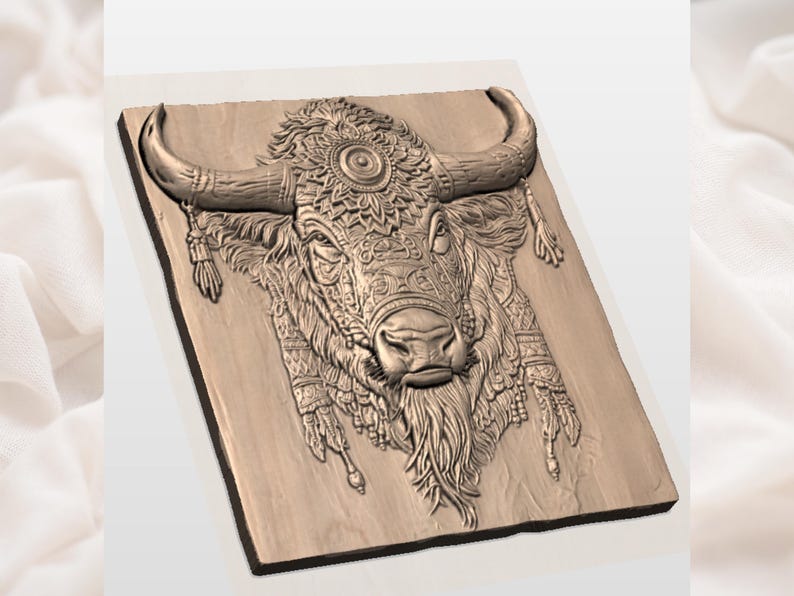 May include: A detailed, carved wooden relief depicting a bull's head. The bull features intricate patterns and designs, including a decorative headdress and dangling ornaments. The artwork is a warm, natural wood tone.