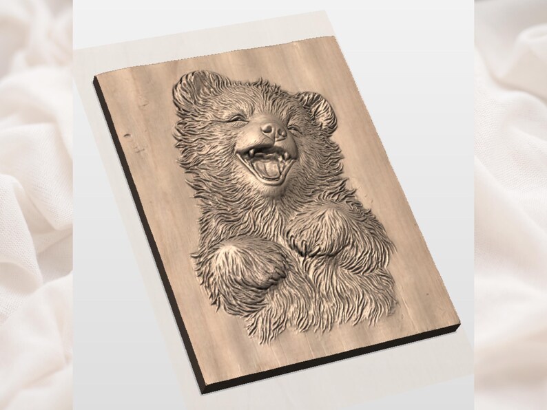 May include: A wooden relief carving of a smiling bear cub. The bear's fur is detailed with textured lines, and its mouth is wide open in a joyful expression. The carving is mounted on a rectangular wooden plaque.