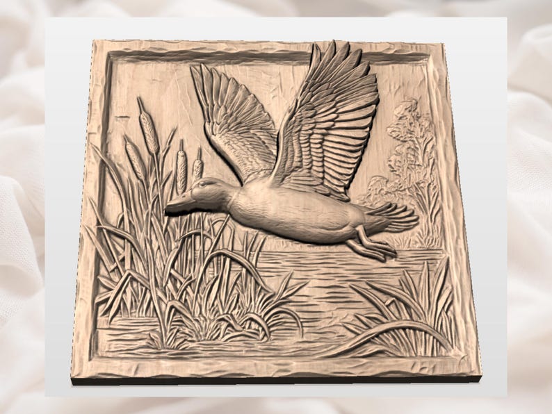 May include: A detailed relief carving of a duck in flight, wings spread, above water and reeds. The artwork is framed within a square, showcasing a naturalistic scene with textured details and a warm, earthy tone.