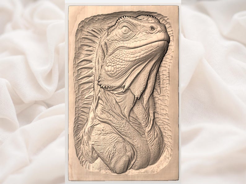 May include: A detailed wood carving of an iguana's head and upper body. The iguana is carved in a relief style, showcasing its textured skin and scales. The carving is set within a rectangular frame.