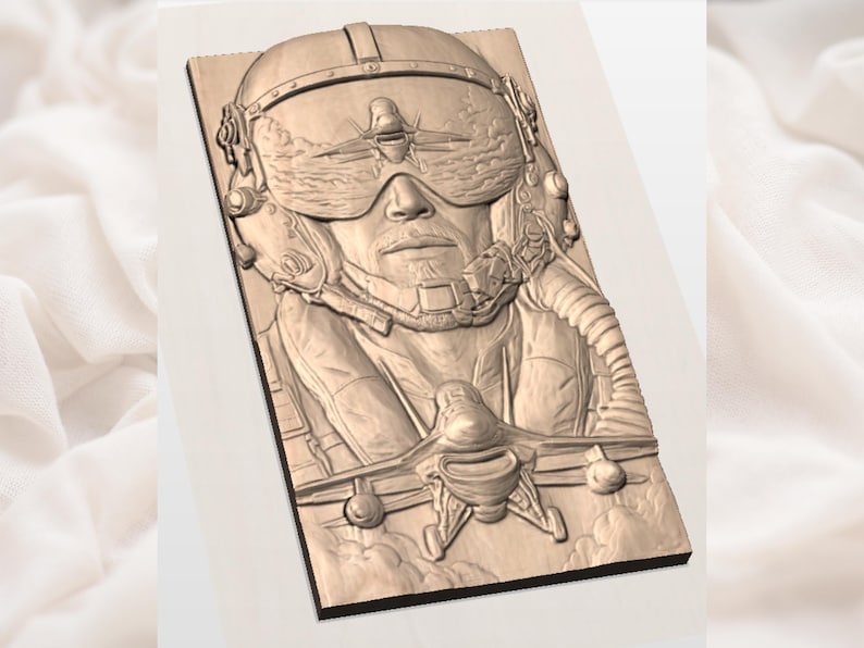 May include: A wooden relief carving of a pilot wearing a helmet and goggles, with a detailed depiction of a fighter jet. The carving is in shades of brown and beige, with intricate details.
