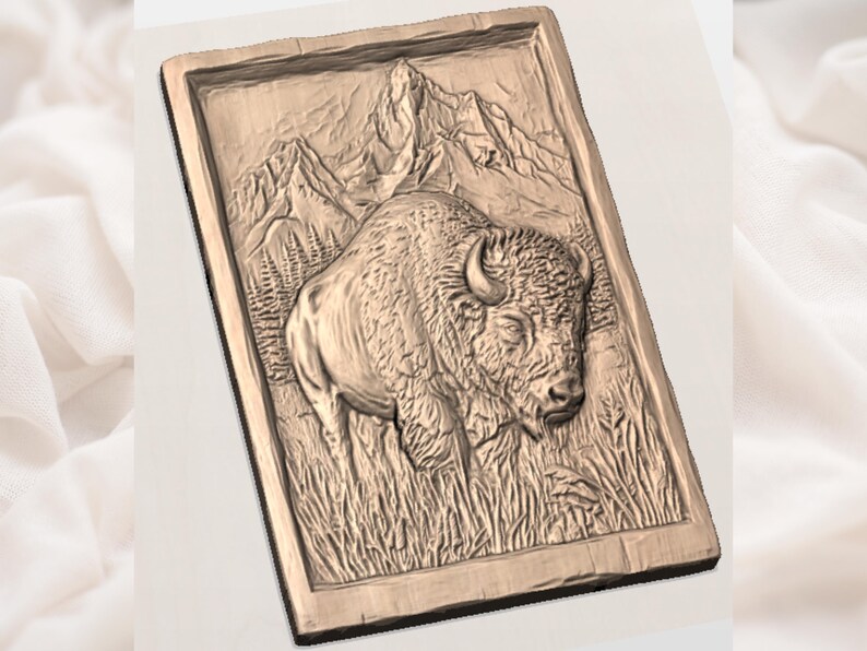 May include: A rectangular, wooden relief carving featuring a bison in a grassy field, with mountains in the background. The bison is detailed with textured fur and horns. The carving is framed with a simple border.