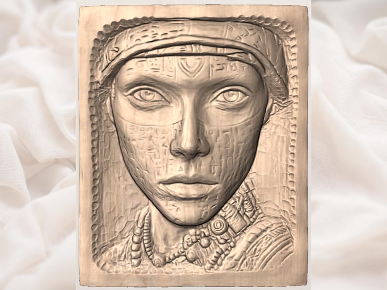 May include: A detailed, relief carving of a woman's face, possibly Egyptian, with intricate details. The carving is set within a rectangular wooden frame, featuring a headdress, facial veil, and ornate jewelry. The artwork is in shades of brown.