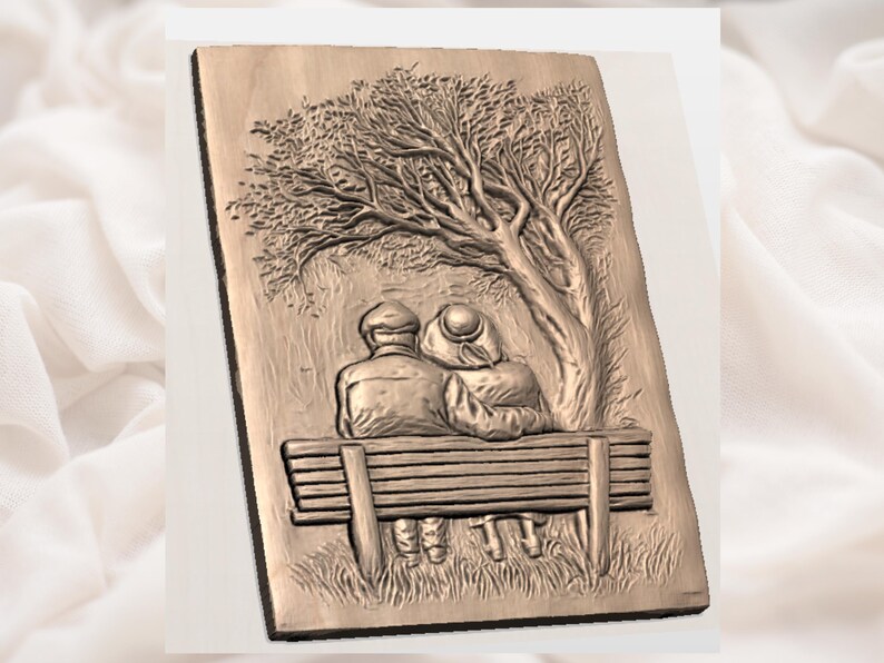 May include: A wooden relief carving depicts an elderly couple seated on a park bench beneath a tree. The artwork is rendered in shades of brown, with detailed textures on the tree, bench, and figures, suggesting a scene of peaceful companionship.