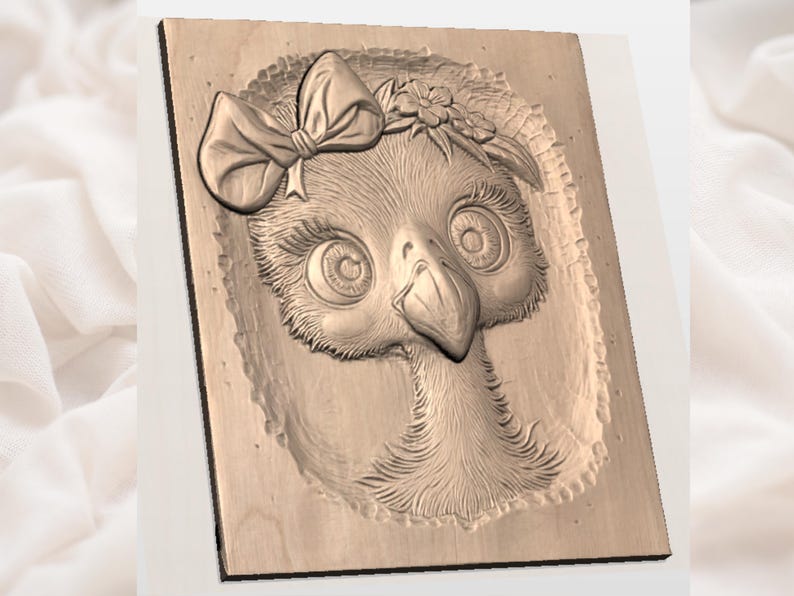 May include: A wooden relief carving of a bird's face, with large eyes, a prominent beak, and a bow. The carving has detailed textured feathers and a floral crown, set against a rectangular wooden background.