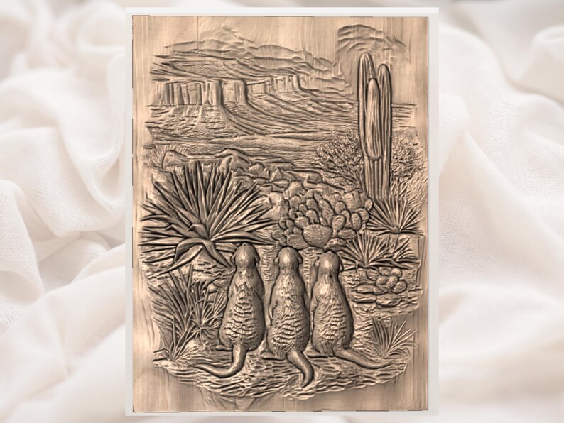 May include: A wooden relief carving depicting a desert scene with three meerkats standing upright, observing the landscape. The artwork features a detailed depiction of cacti, desert plants, and rock formations, all rendered in shades of brown.