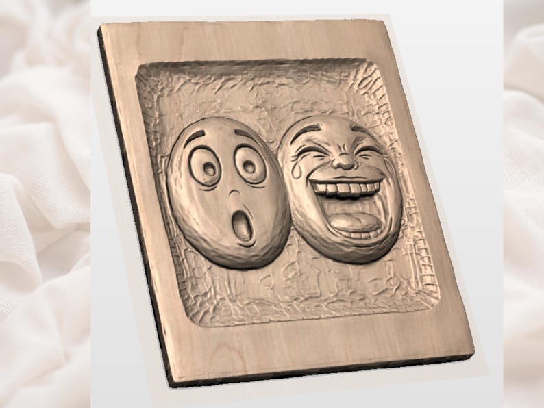 May include: A wooden plaque featuring two carved emoji faces: one with wide eyes and an open mouth, the other laughing with tears. The faces are in a recessed area within a rectangular frame, showcasing a detailed relief.