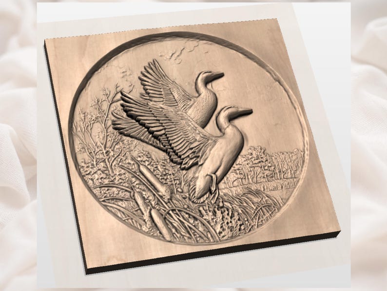 May include: A wooden relief carving of two ducks in a naturalistic setting. The ducks are depicted with detailed feathers and are set against a backdrop of reeds, trees, and a cloudy sky. The artwork is framed within a circular border.