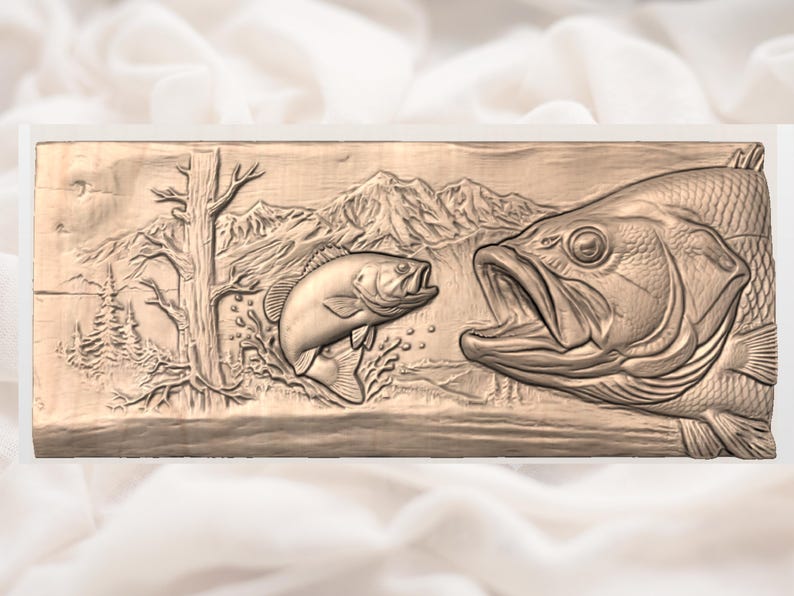 May include: A rectangular, relief carving depicting two fish in a natural setting. One fish is large with an open mouth, and the other is smaller. The background includes trees, mountains, and water, all carved in a light brown color.