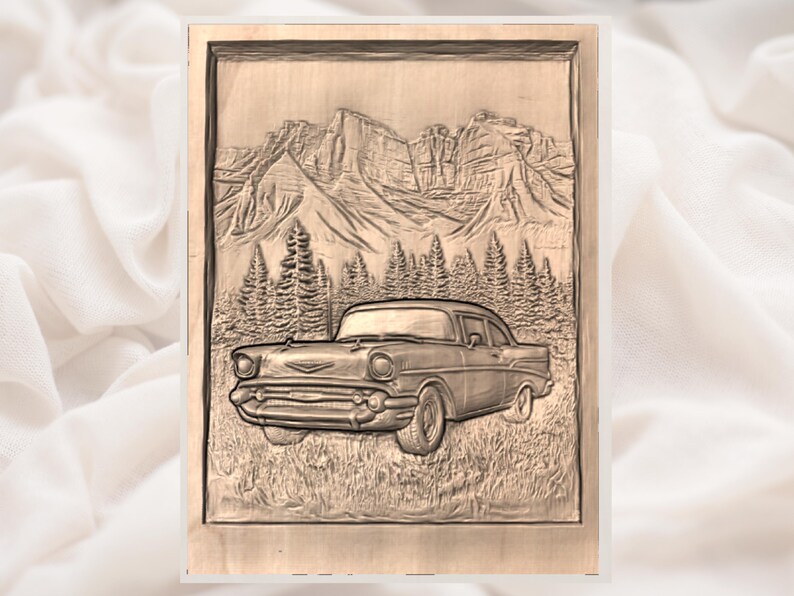 May include: A wooden relief carving depicting a classic car in a mountain landscape. The car is a vintage model, set against a backdrop of detailed mountains and pine trees. The artwork is framed in a light-colored wooden border.