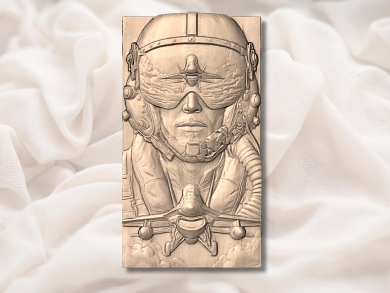 May include: A detailed wooden carving of a pilot wearing a helmet with a visor, and a breathing apparatus. The carving also features a fighter jet in the foreground, with clouds in the background. The artwork is in shades of brown.