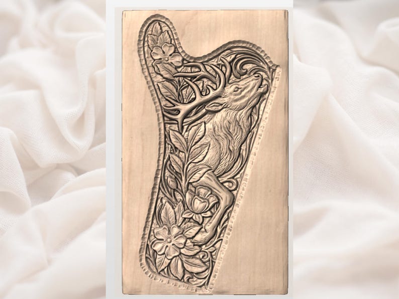 May include: A light brown wooden carving, rectangular in shape, depicting a deer within a harp-shaped frame. The relief carving includes floral and foliage details. The deer's head is raised.