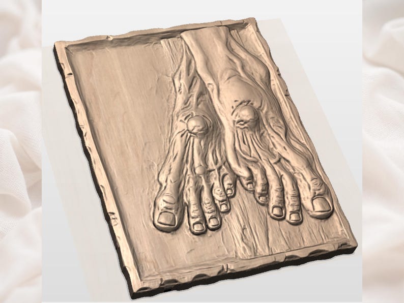 May include: A detailed, bronze-colored relief sculpture of two feet, showcasing intricate details of toes, nails, and skin texture. The feet are positioned side-by-side on a rectangular base with a textured border, creating a three-dimensional effect.