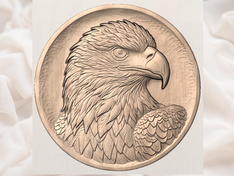 May include: A detailed, circular relief carving of an eagle's head and upper body. The eagle is depicted in profile, with intricate feather detailing and a sharp beak. The carving is in a warm, natural wood tone.