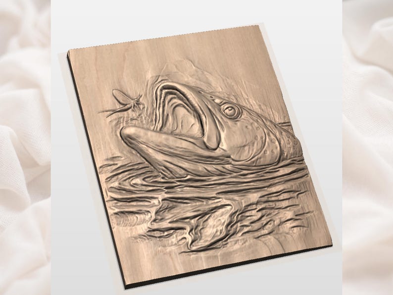 May include: A wooden relief carving of a fish with its mouth open, about to catch a fly. The artwork is set against a light background. The fish is depicted in detail, with visible scales and water ripples.