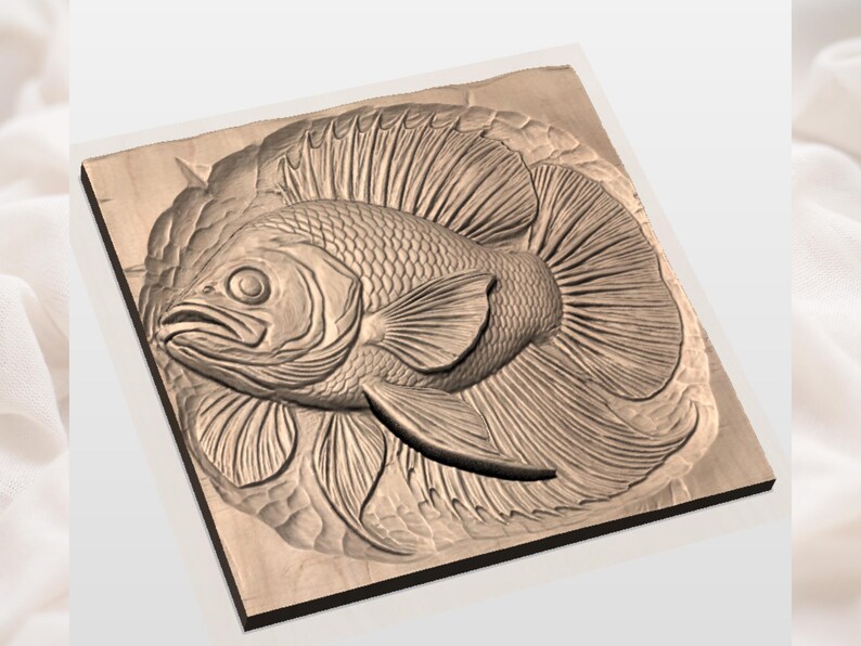 May include: A detailed wood carving of a fish with large fins and scales. The fish is centered on a square wooden plaque, with intricate details carved into the wood. The carving is in shades of brown.