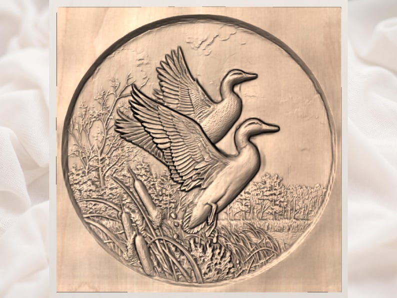 May include: A detailed wood carving of two ducks in flight, set within a circular frame. The ducks are depicted with outstretched wings, above a detailed landscape of reeds, grass, and trees. The carving is in shades of brown.